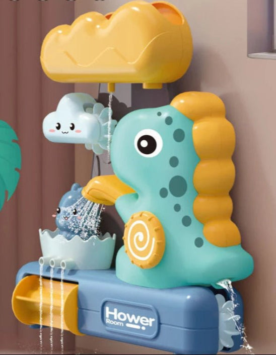 Le Jouet de bain - dinosaure se fixe au mur et comprend un dinosaure bleu sarcelle, un récipient jaune, un nuage et une roue à eau pour une aventure de bain amusante alors que plusieurs jets d'eau traversent différentes sections.