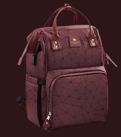 Le « Sac à Langer dos » est un sac à dos marron à motifs géométriques, idéal pour les parents modernes et les sorties en famille. Il est doté d'un port de charge, d'un compartiment spécial et d'un compartiment arrière. Affiché sur une surface blanche avec une petite plante en arrière-plan, ses caractéristiques sont étiquetées en français.